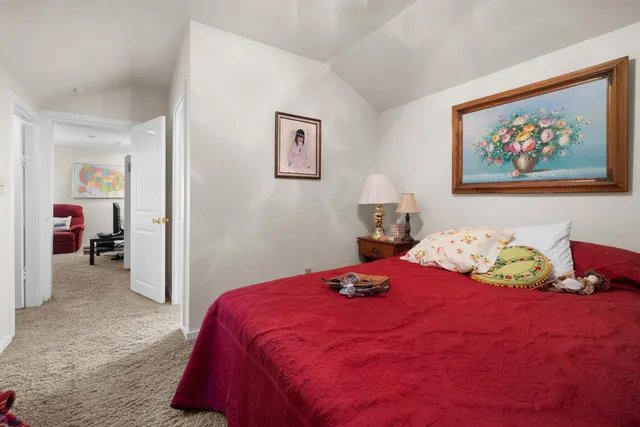 a bedroom with bed and wall painting