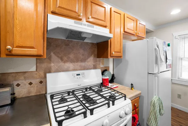 a kitchen with a stove and a refrigerator