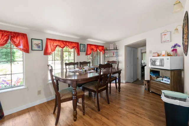 a view of a dining room with furniture and wooden floor