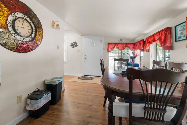 a view of a dining room with furniture a chandelier and wooden floor
