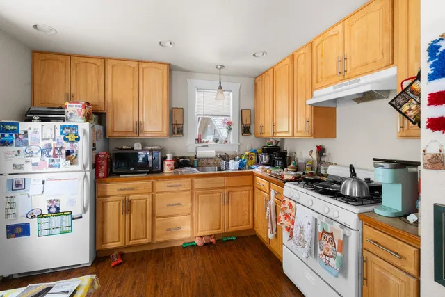 a kitchen with stainless steel appliances a stove a sink and a refrigerator