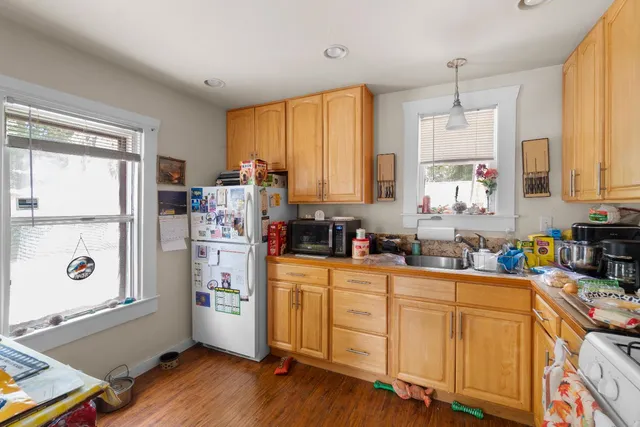 a kitchen with stainless steel appliances a refrigerator sink and cabinets