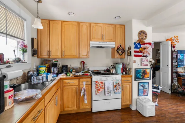 a kitchen with a refrigerator and a stove top oven