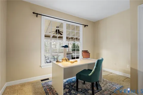 a room with pool table and windows