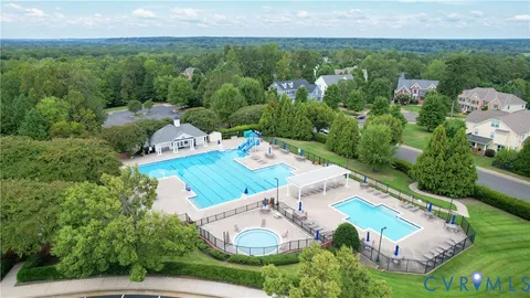 an aerial view of a house with garden space and street view