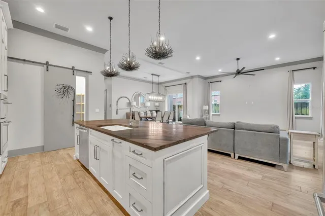 a kitchen with stainless steel appliances granite countertop a sink a oven and a refrigerator