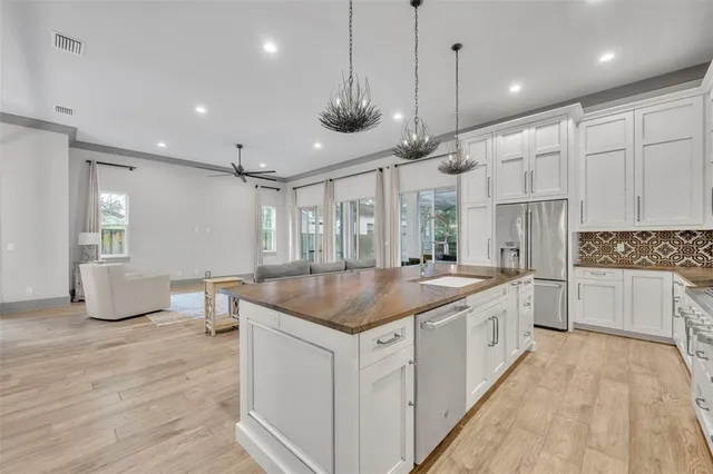 a kitchen with stainless steel appliances granite countertop a sink and cabinets
