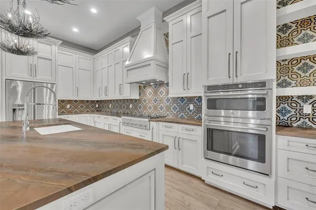 a kitchen with cabinets appliances and a counter space