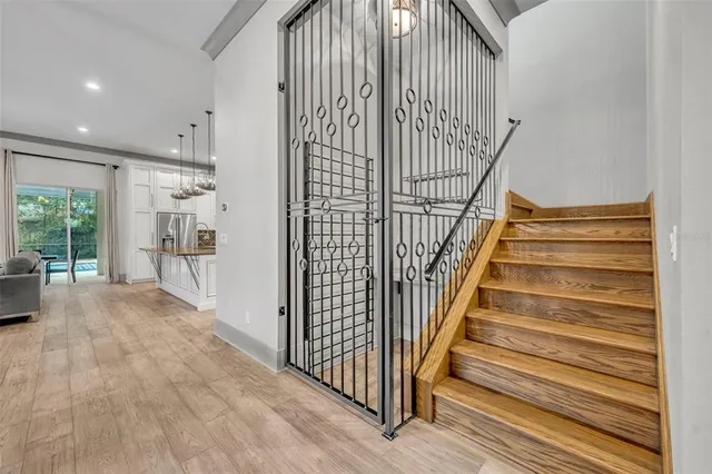 a view of entryway with wooden floor and stairs