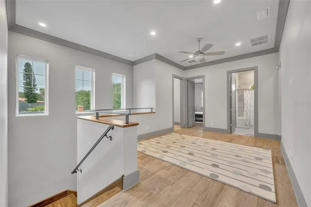 a view of a room with a window and a ceiling fan