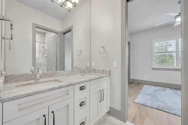 a bathroom with a granite countertop sink a mirror and a
