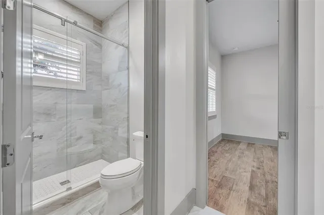 a bathroom with a toilet and a shower