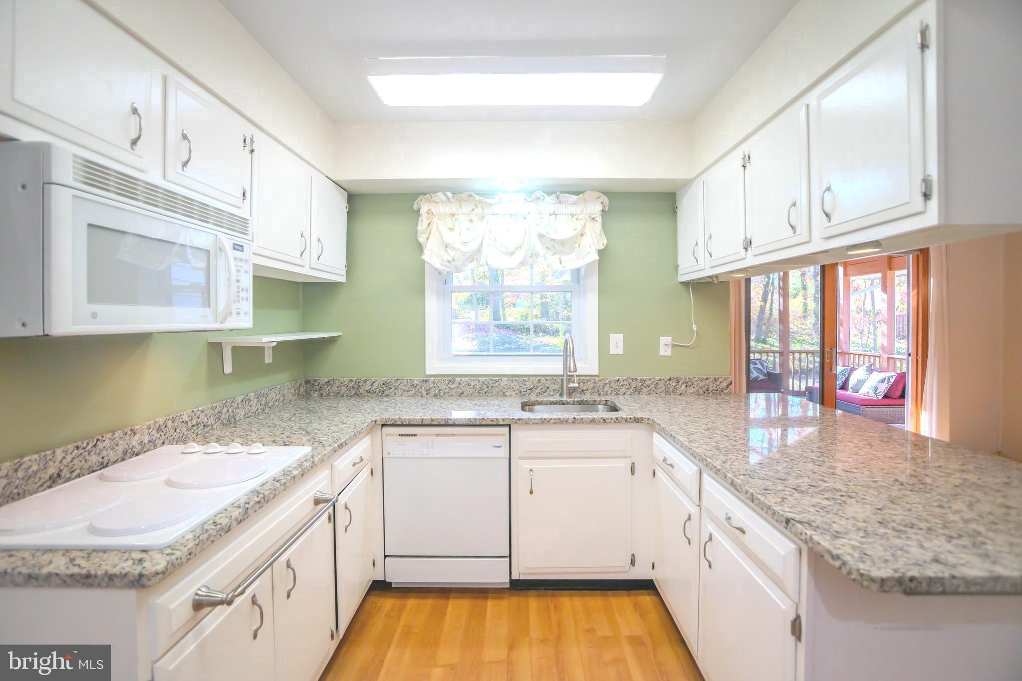 8815 Gramercy Lane Laurel, MD 20708 - Photo 11 of 42 a kitchen with granite countertop a sink a stove and cabinets