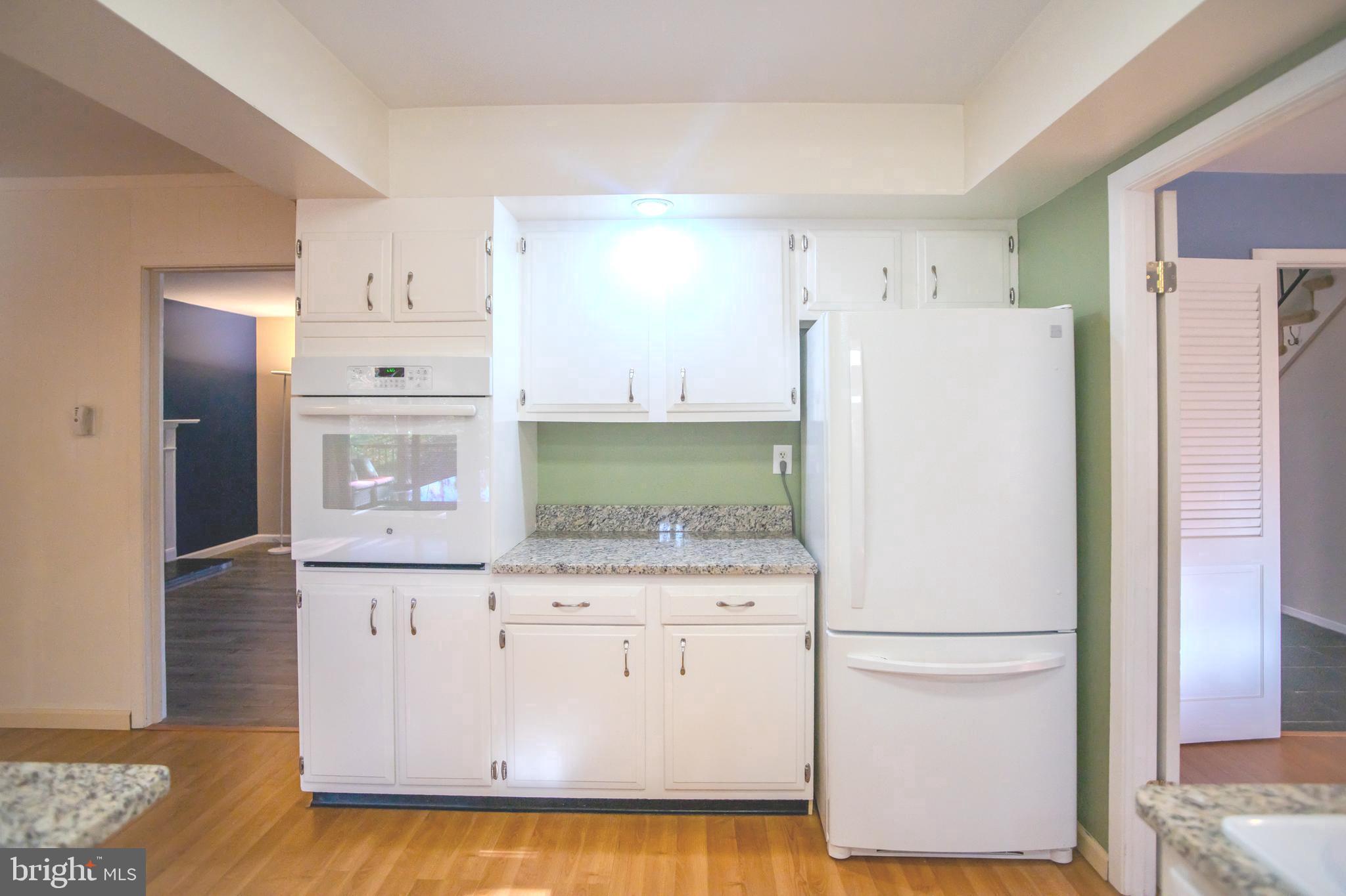 8815 Gramercy Lane Laurel, MD 20708 - Photo 12 of 42 a white refrigerator freezer sitting inside of a kitchen
