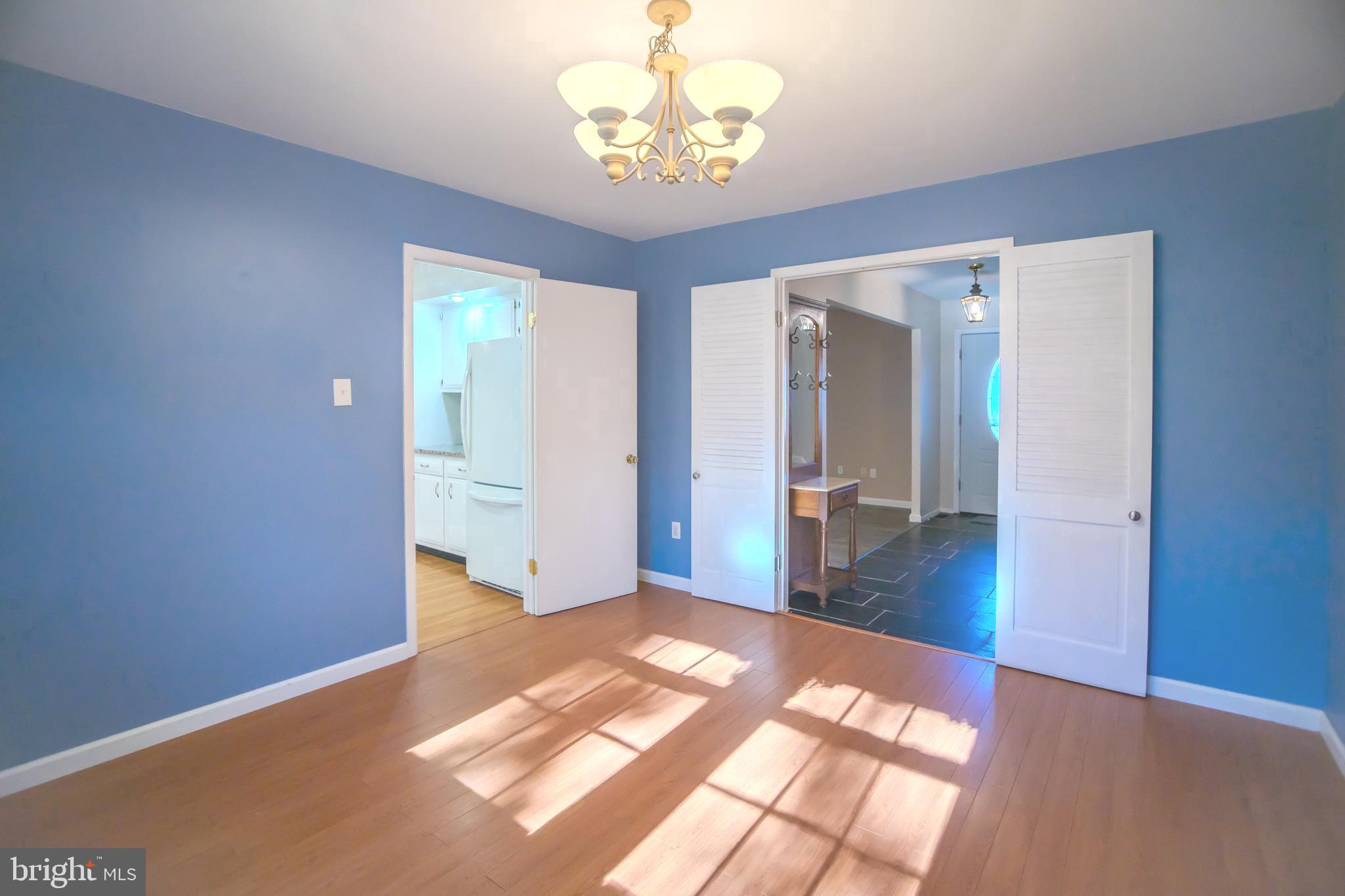 8815 Gramercy Lane Laurel, MD 20708 - Photo 14 of 42 a bedroom with wooden floor and chandelier