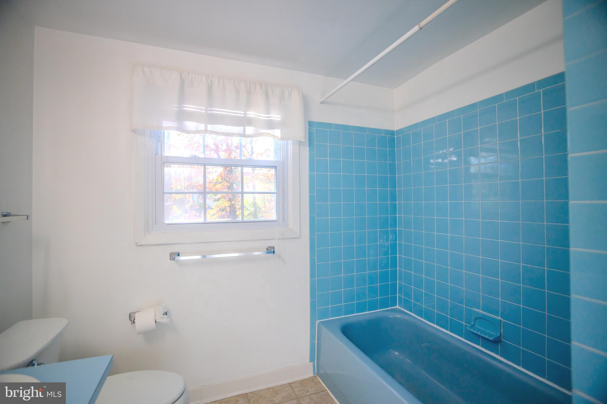 8815 Gramercy Lane Laurel, MD 20708 - Photo 30 of 42 a bathroom with a bathtub and window