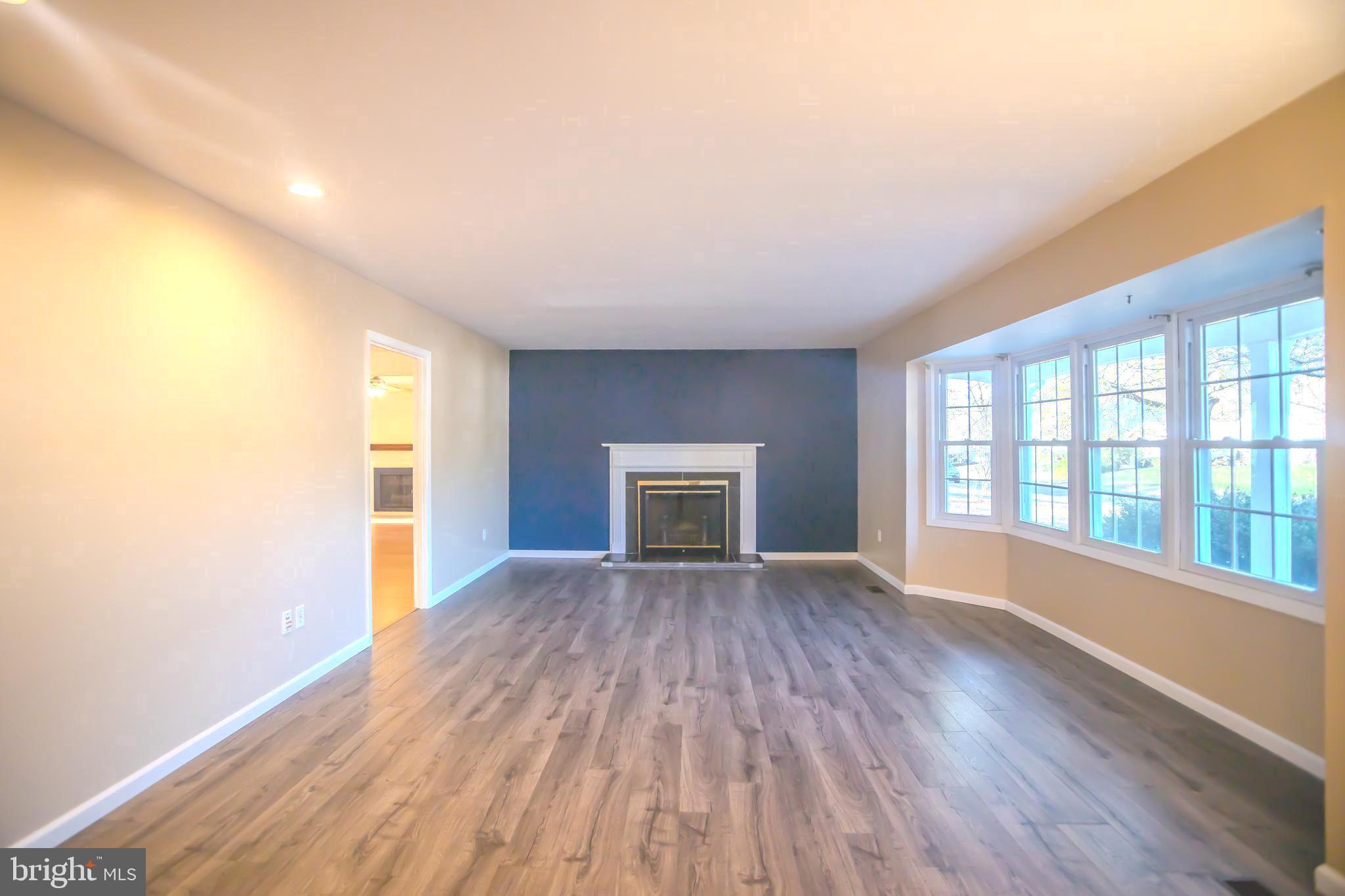8815 Gramercy Lane Laurel, MD 20708 - Photo 4 of 42 wooden floor in an empty room with a window