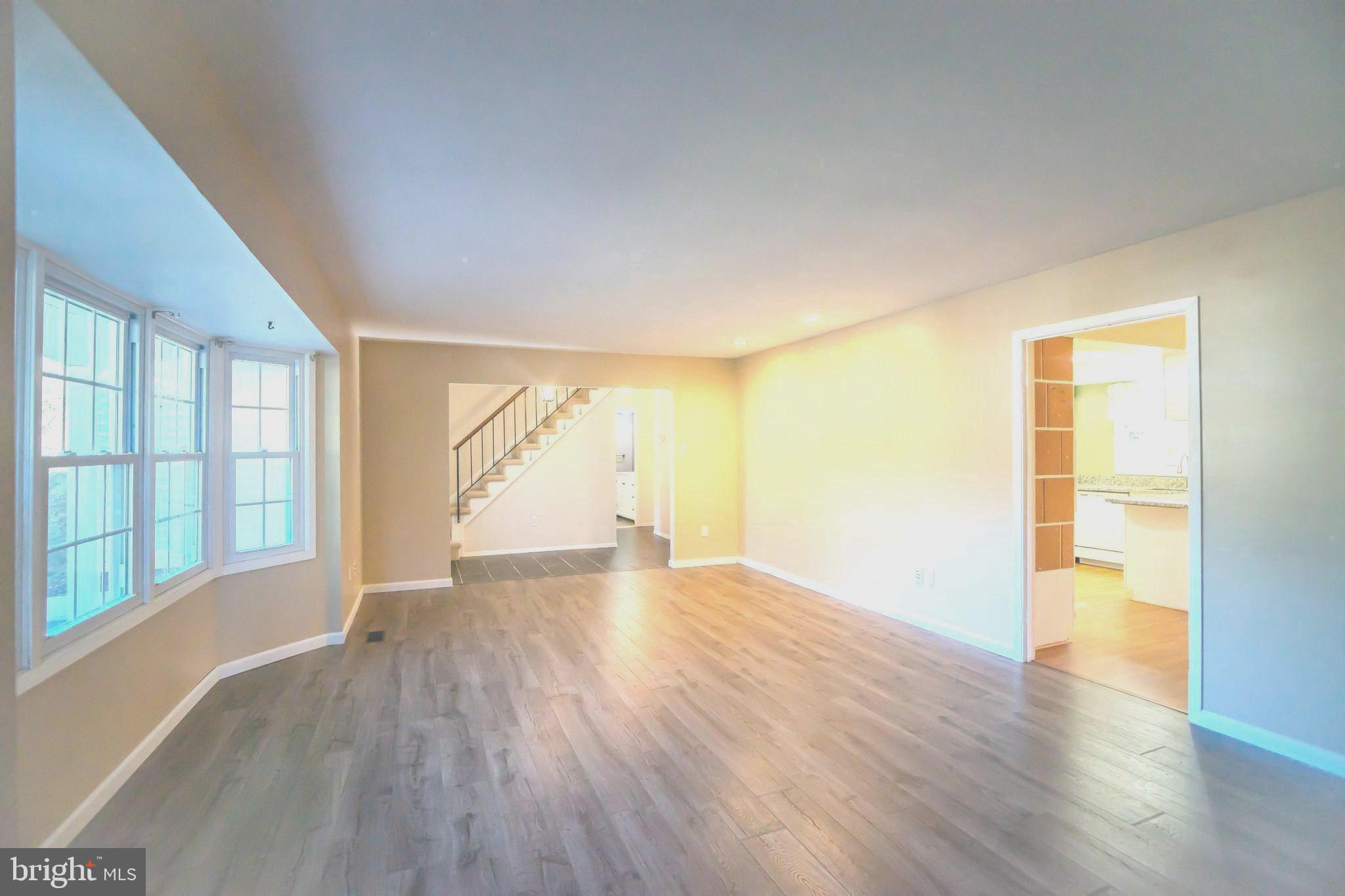 8815 Gramercy Lane Laurel, MD 20708 - Photo 5 of 42 an empty room with wooden floor and windows
