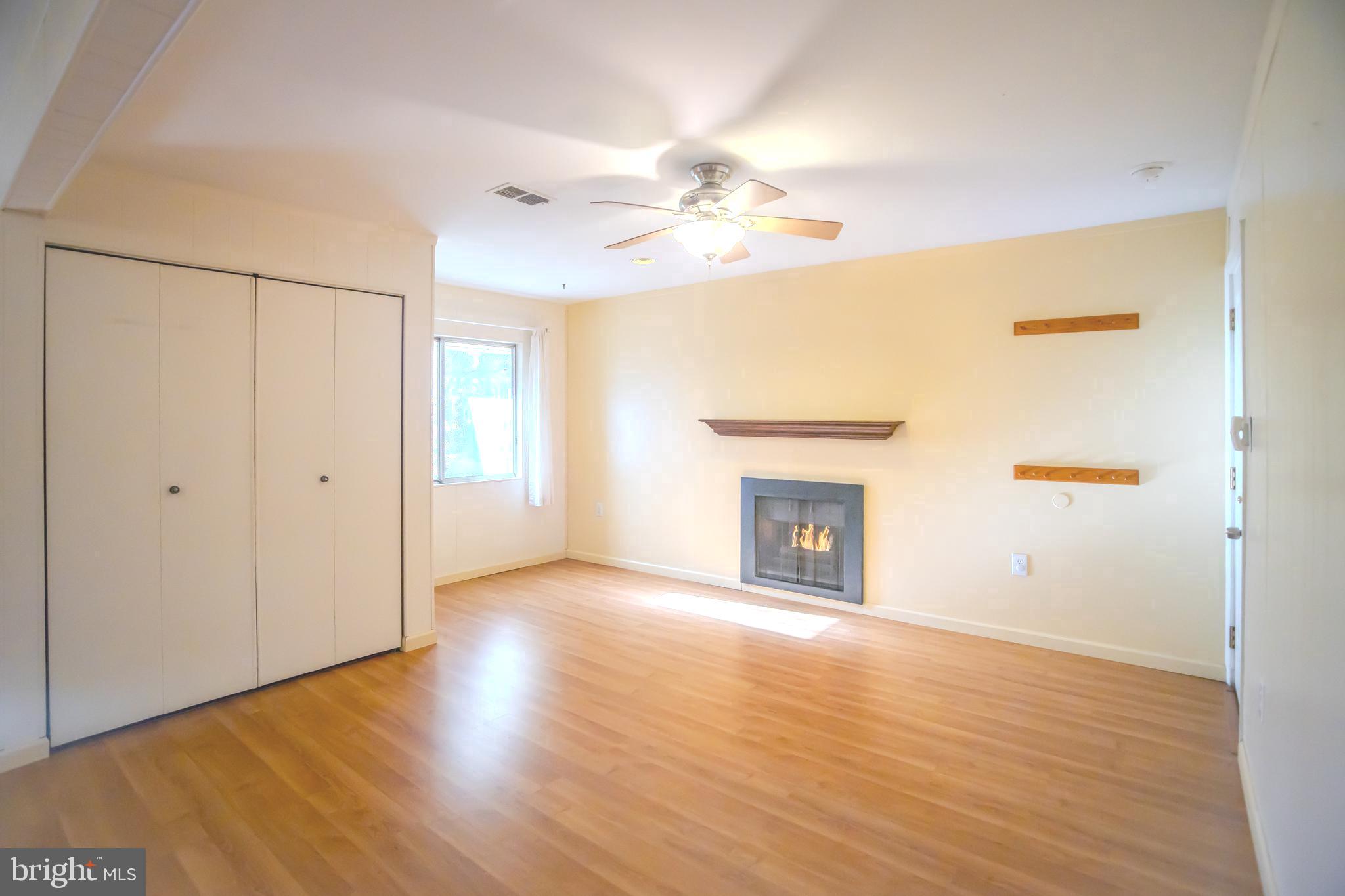 8815 Gramercy Lane Laurel, MD 20708 - Photo 7 of 42 a view of an empty room with window and wooden floor