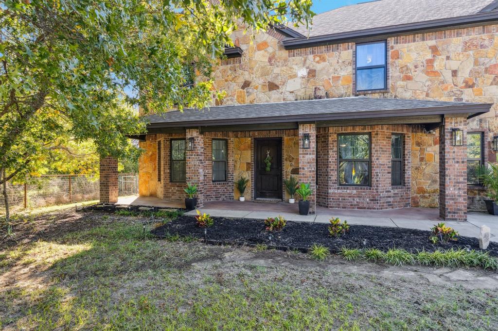 3390 Zion Hill Road Weatherford, TX 76088 - Photo 2 of 40 a view of a house with a backyard and porch