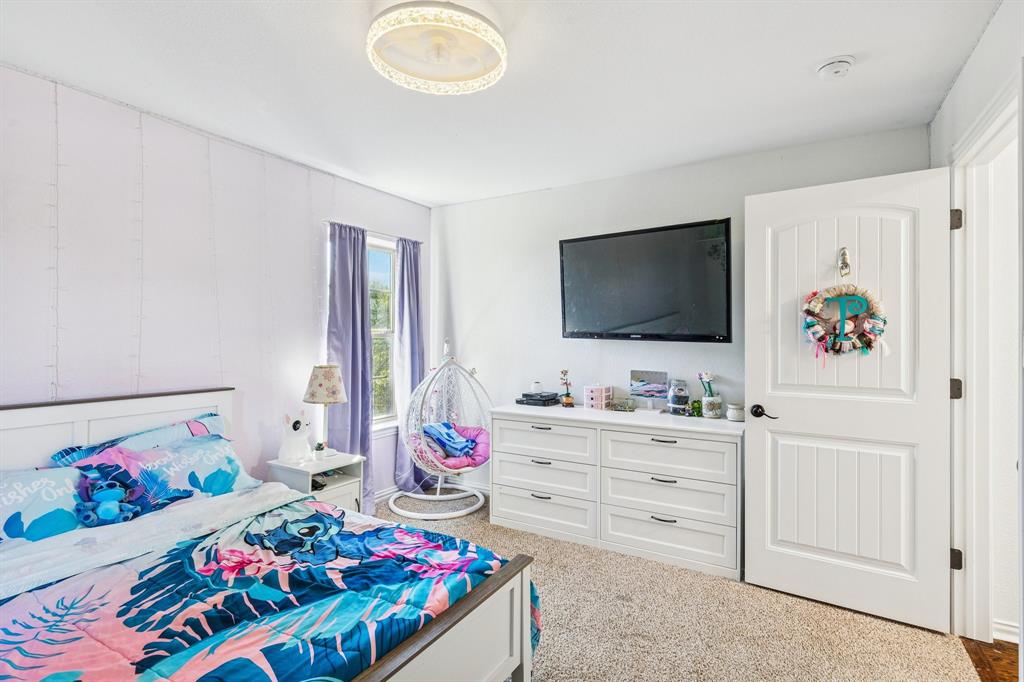 3390 Zion Hill Road Weatherford, TX 76088 - Photo 22 of 40 a bedroom with a bed and flat screen tv