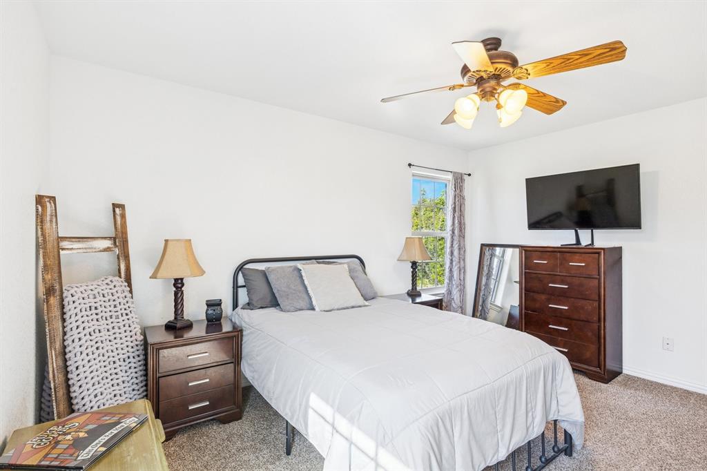 3390 Zion Hill Road Weatherford, TX 76088 - Photo 25 of 40 a bedroom with a bed and a flat screen tv