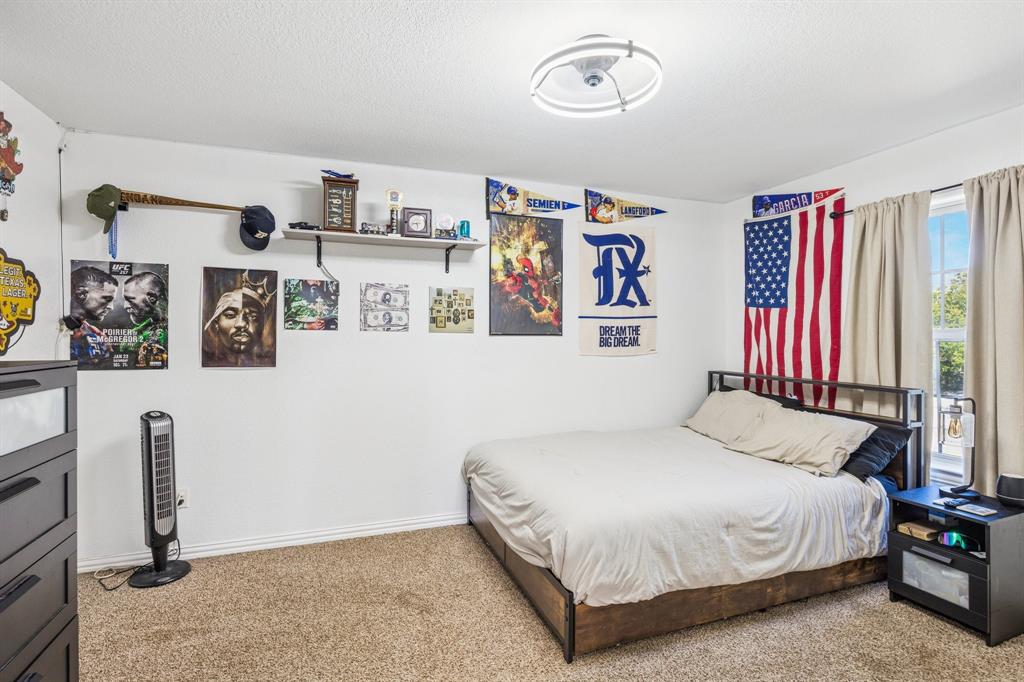 3390 Zion Hill Road Weatherford, TX 76088 - Photo 26 of 40 a bedroom with a bed and a book shelf