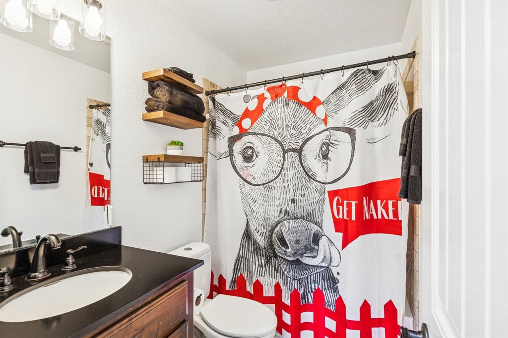 3390 Zion Hill Road Weatherford, TX 76088 - Photo 28 of 40 a bathroom with a toilet and a sink