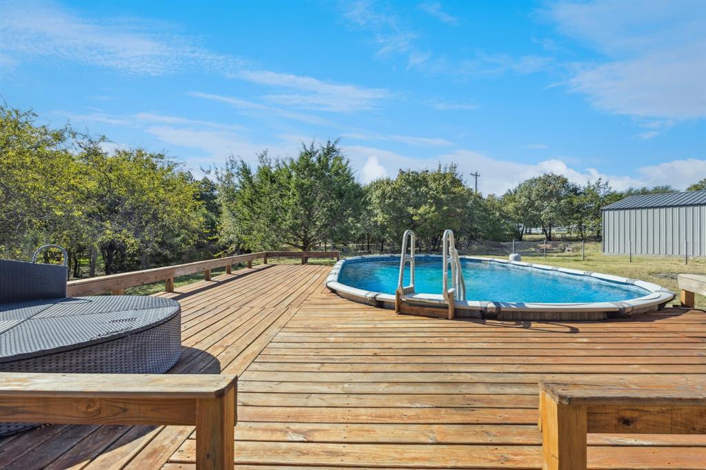 3390 Zion Hill Road Weatherford, TX 76088 - Photo 35 of 40 a view of a swimming pool with an outdoor seating