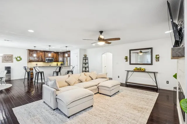 a living room with furniture and wooden floor