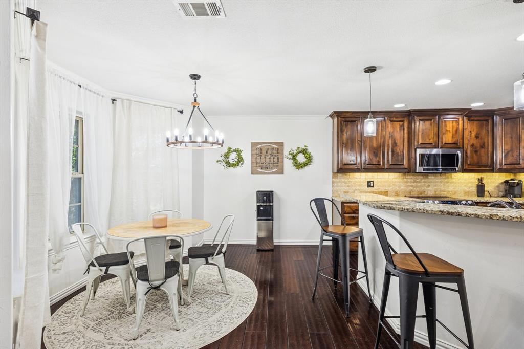 3390 Zion Hill Road Weatherford, TX 76088 - Photo 8 of 40 a dining room with furniture a chandelier and wooden floor