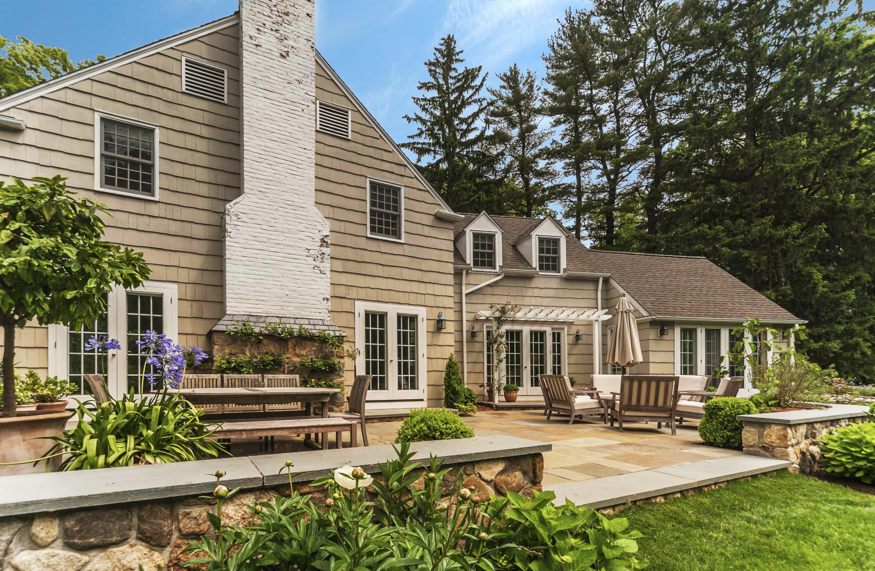 4 Point O Woods Road Darien, CT 06820 - Photo 20 of 23 a front view of a house with garden