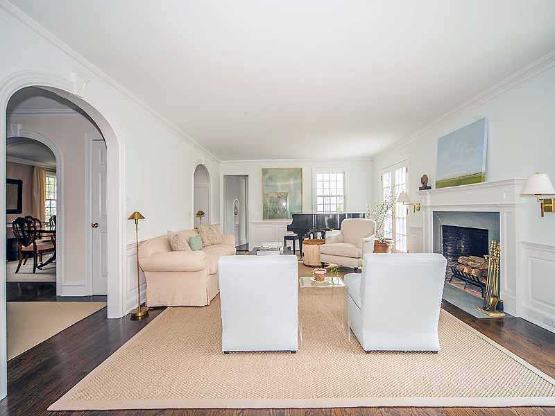 4 Point O Woods Road Darien, CT 06820 - Photo 3 of 23 a living room with couches a coffee table and a fireplace with wooden floor