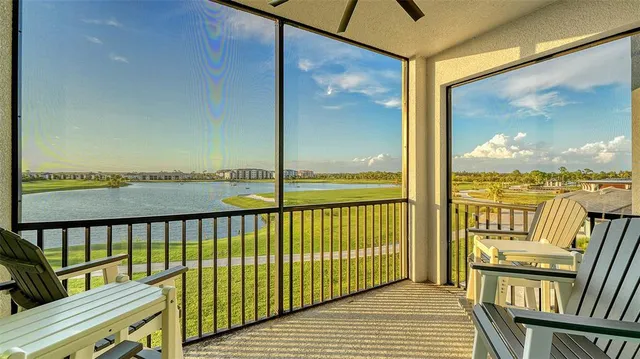 a kitchen with stainless steel appliances kitchen island granite countertop a dining table chairs refrigerator and microwave