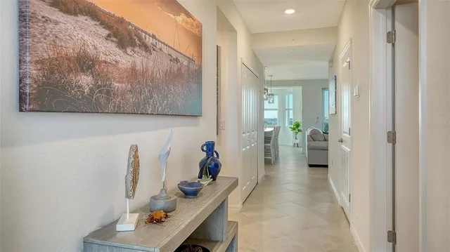 a living room with furniture a ceiling fan and a floor to ceiling window