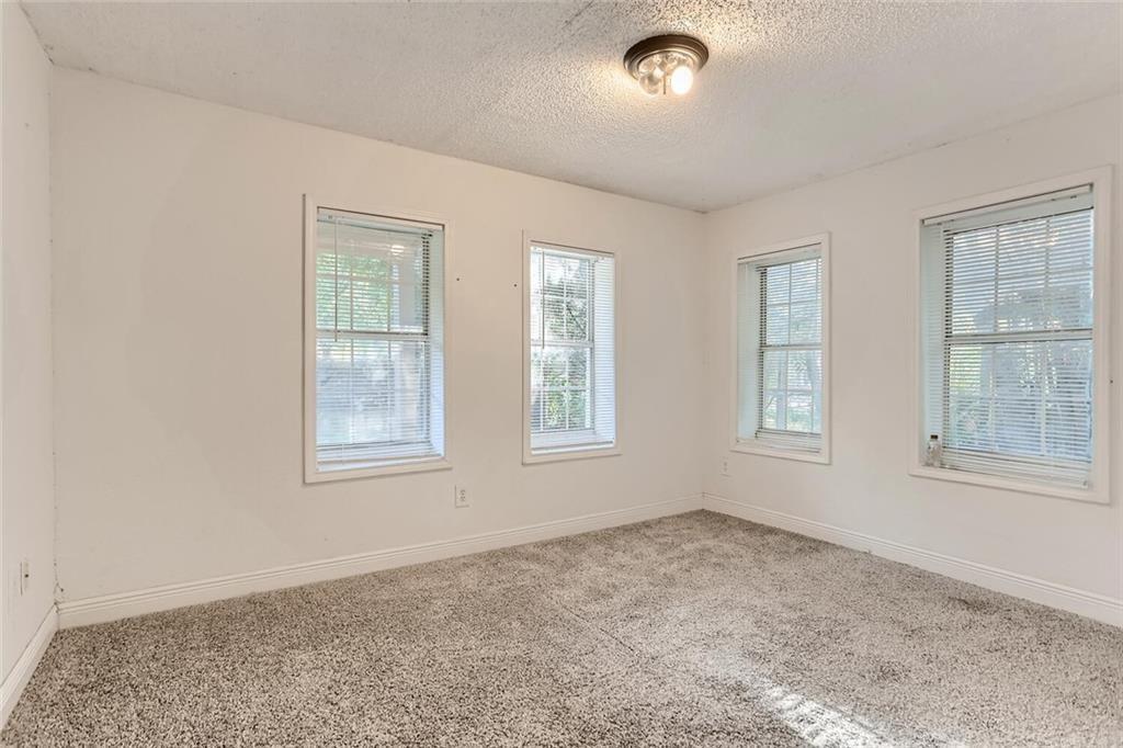 1148 1/2 Gunter Street, Unit A Austin, TX 78721 - Photo 2 of 10 an empty room with windows