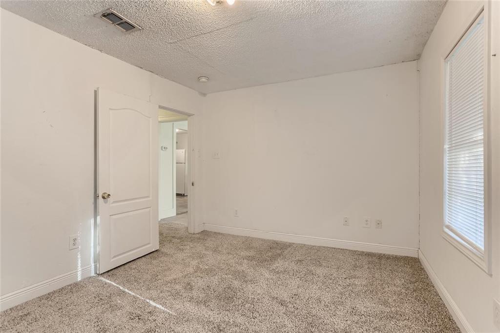 1148 1/2 Gunter Street, Unit A Austin, TX 78721 - Photo 4 of 10 an empty room with windows