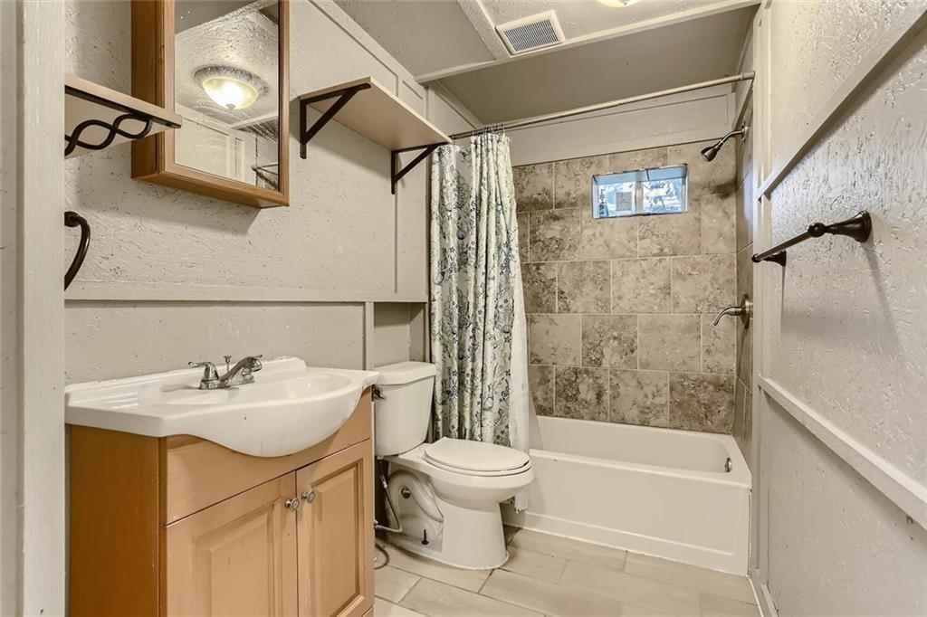 1148 1/2 Gunter Street, Unit A Austin, TX 78721 - Photo 5 of 10 a bathroom with a sink toilet and shower