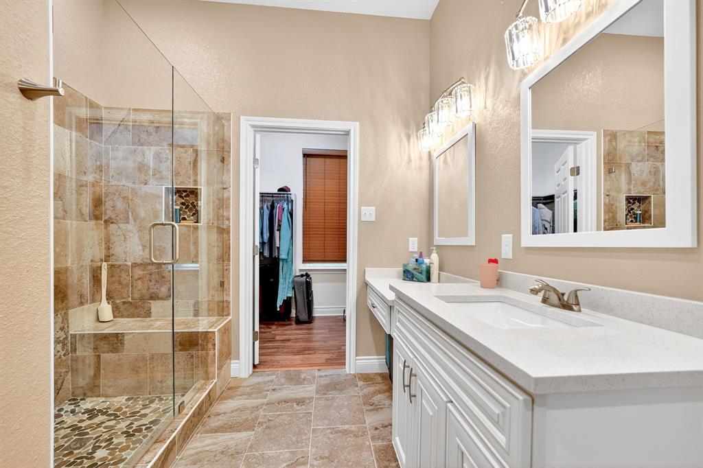 5230 Esquire Estates Road Mabank, TX 75156 - Photo 23 of 39 Spacious bathroom featuring a glass-enclosed shower with a built-in bench and pebble flooring