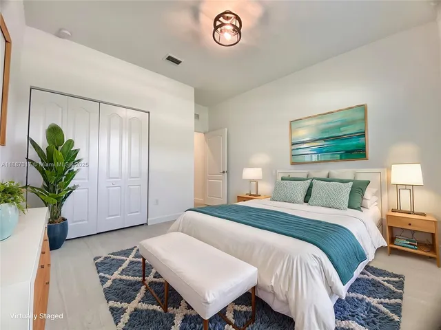 a bed room with a bed and a potted plant