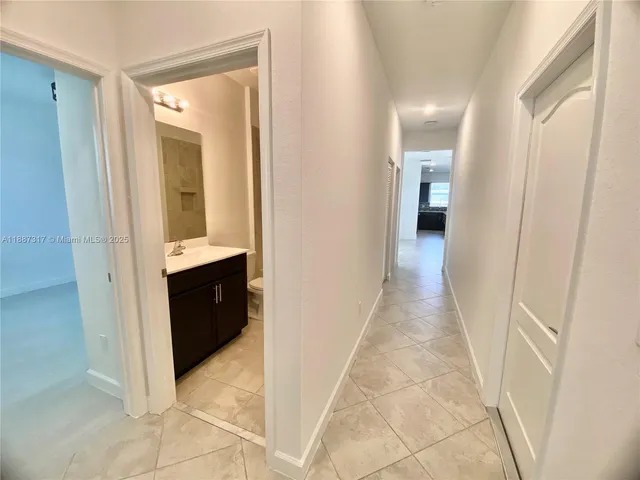 a view of a bathroom from the hallway