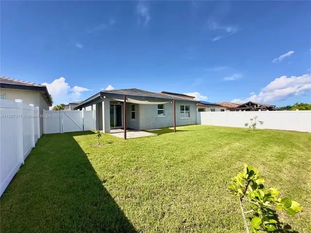 a view of a house with a backyard