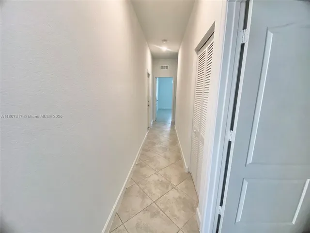 a view of a living room and kitchen with windows
