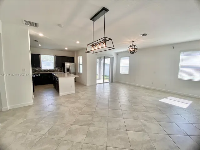 a kitchen with stainless steel appliances a refrigerator a stove a microwave a sink and a refrigerator