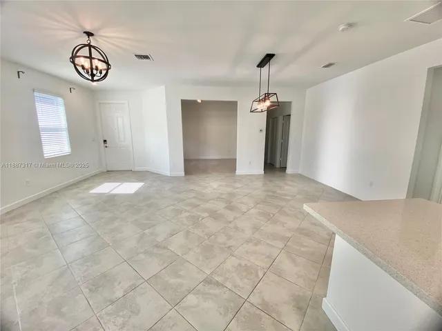 a view of a kitchen with a sink and a window