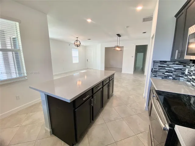 a kitchen with a stove sink and a refrigerator