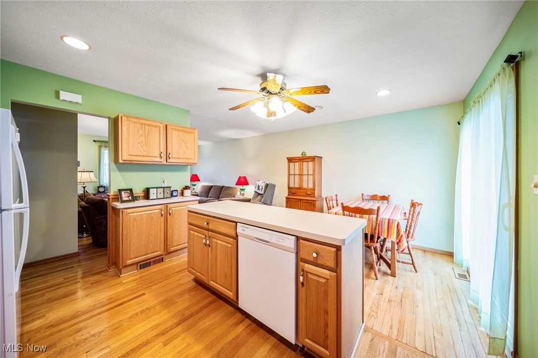 30888 Harrison Road Wickliffe, OH 44092 - Photo 11 of 33 Kitchen featuring white appliances, light wood finished floors, ceiling fan, light countertops, and recessed lighting