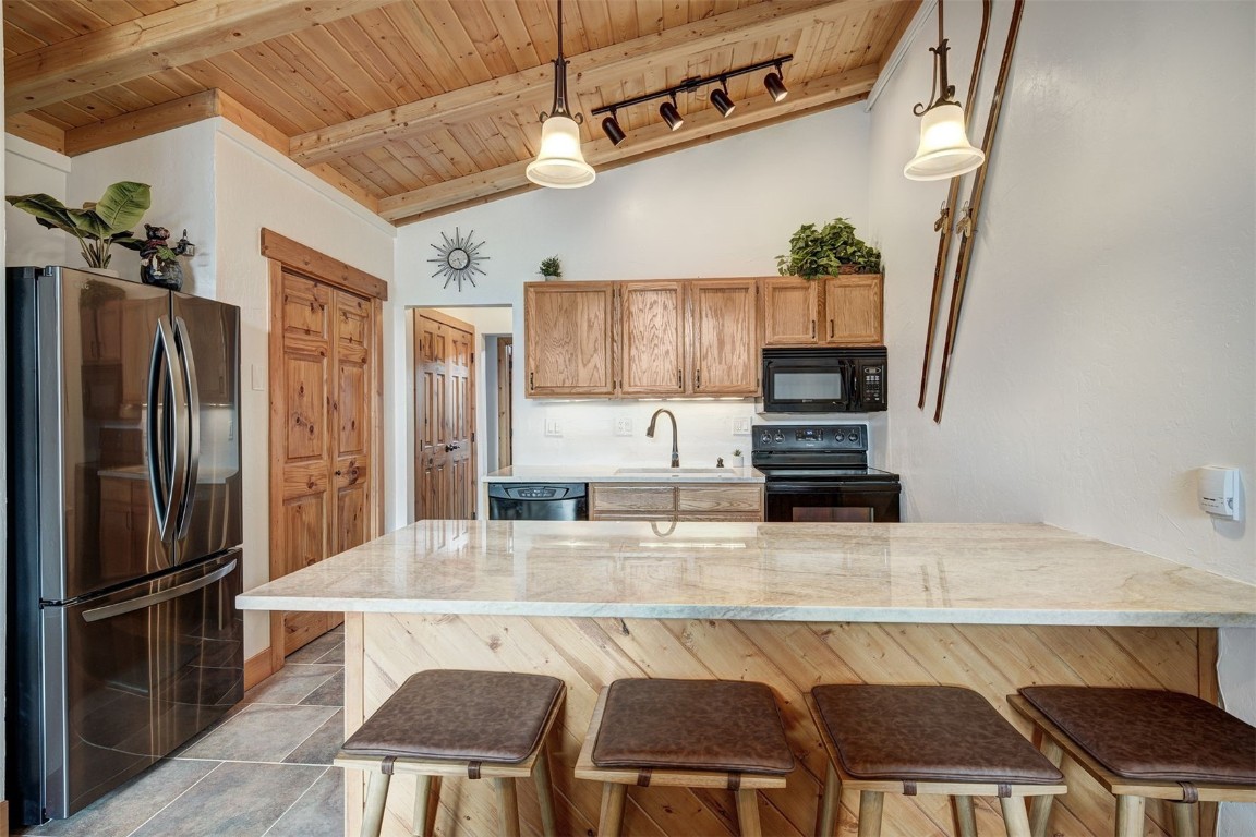 1473 East Keystone Road, Unit 2933 Keystone, CO 80435 - Photo 4 of 18 a kitchen with stainless steel appliances granite countertop a sink refrigerator and cabinets