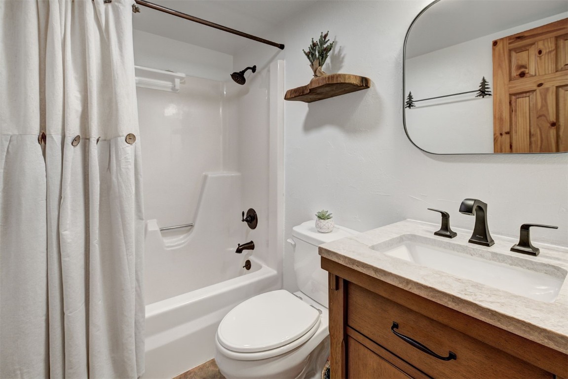 1473 East Keystone Road, Unit 2933 Keystone, CO 80435 - Photo 9 of 18 a bathroom with a granite countertop sink toilet a mirror and shower