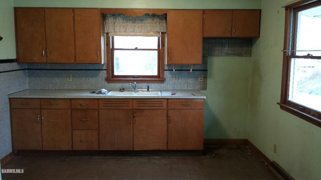 305 East State Road Mount Carroll, IL 61053 - Photo 3 of 10 a kitchen with a sink cabinets and a window